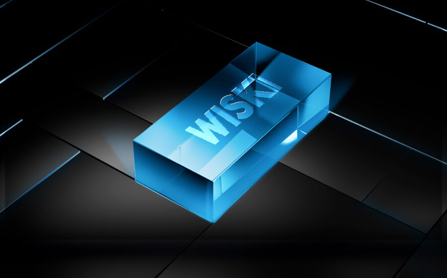 Un bloque rectangular 3D azul transparente sobre una superficie oscura y reflectante. El bloque lleva la palabra