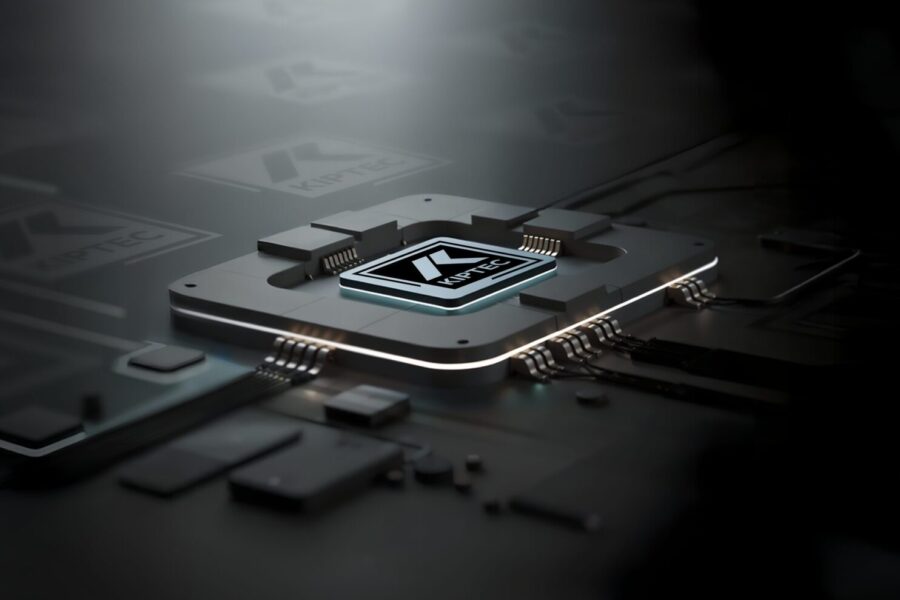 A close-up of a computer microchip on a dark circuit board, illuminated by a bright light from above, highlighting the chip’s metallic details and intricate connections.